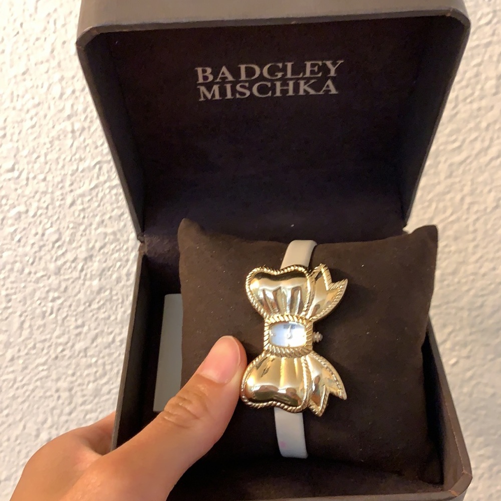 Gold bow with white band watch